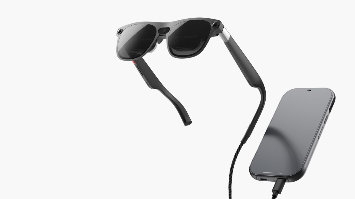 Xreal Aura glasses floating above the phone-like compute puck they plug into